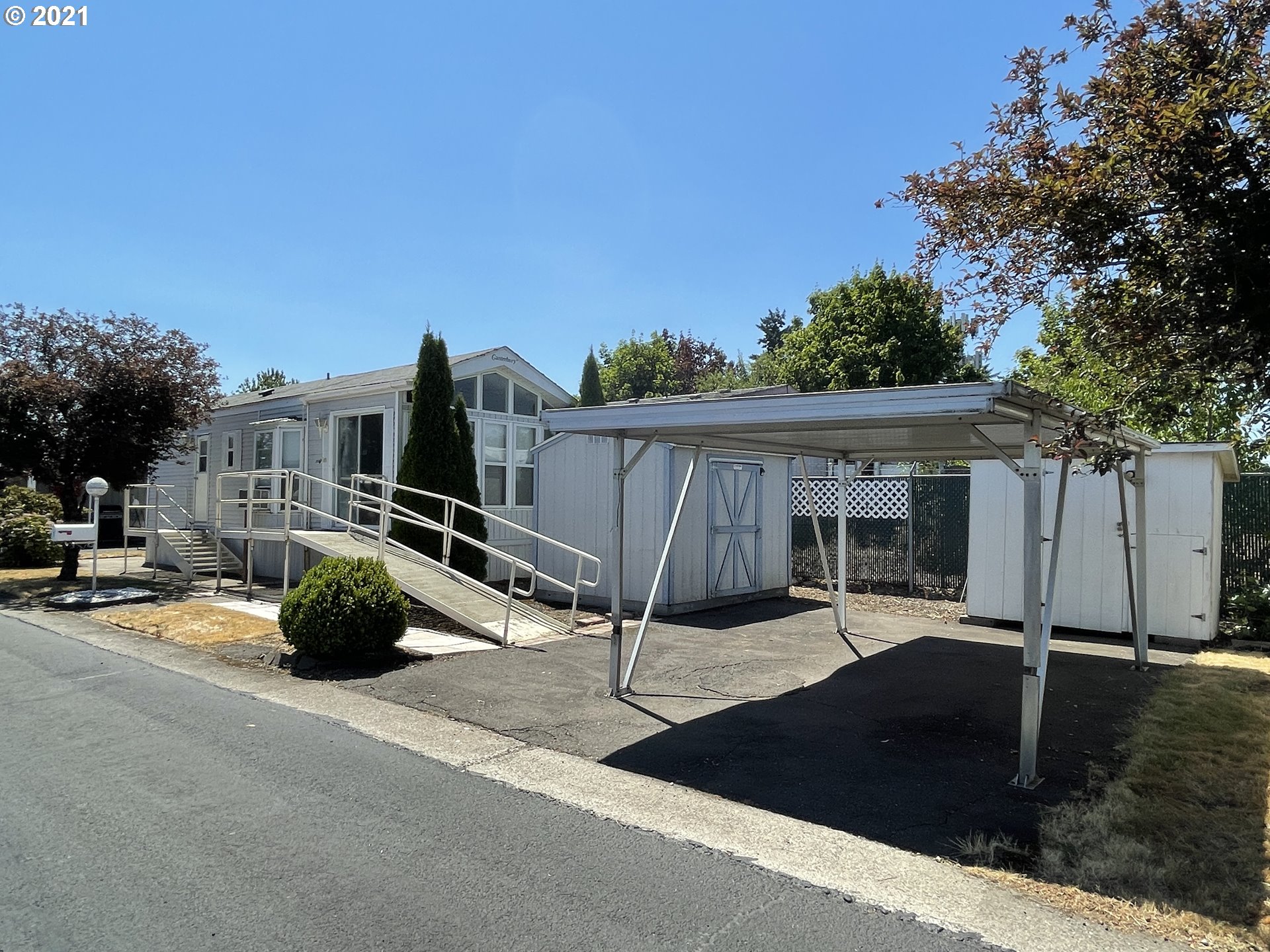 19776 Southeast Stark Street Portland, OR 97233 - Photo 2 of 18 a view of a street with potted plants and a car park