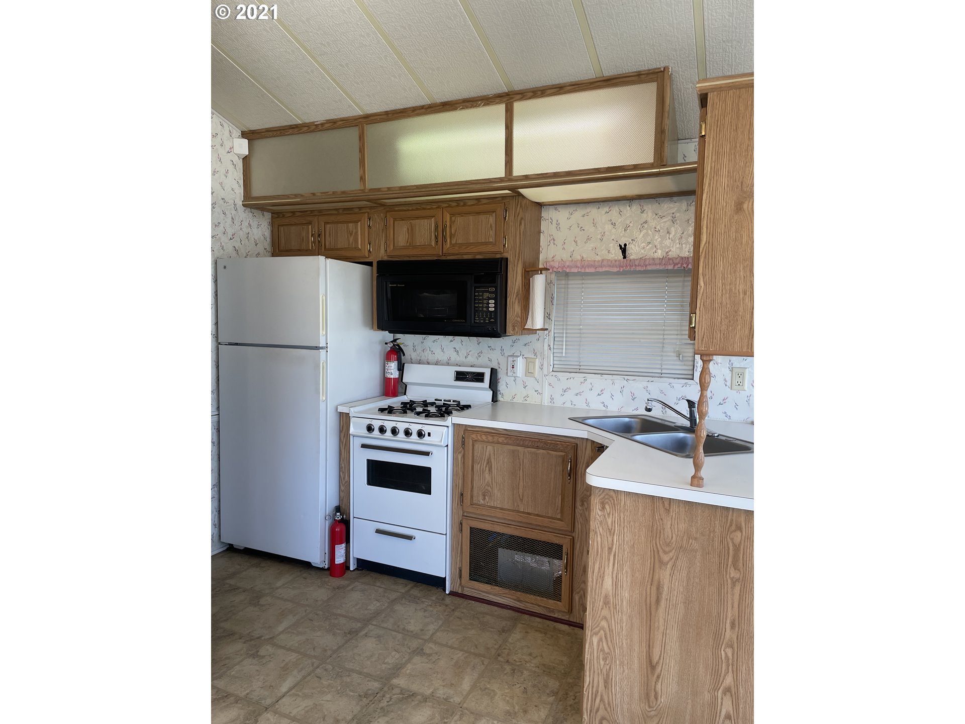 19776 Southeast Stark Street Portland, OR 97233 - Photo 4 of 18 a kitchen with stainless steel appliances a sink and cabinets