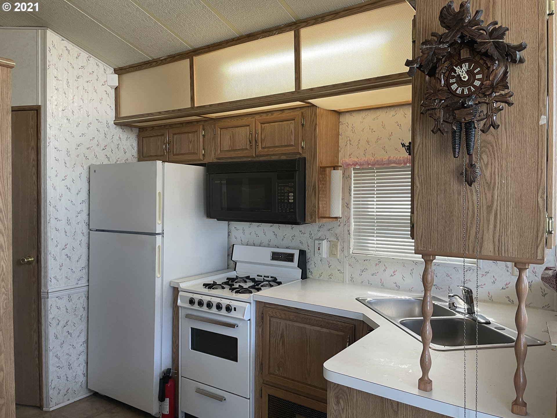 19776 Southeast Stark Street Portland, OR 97233 - Photo 5 of 18 a kitchen with a sink and a refrigerator