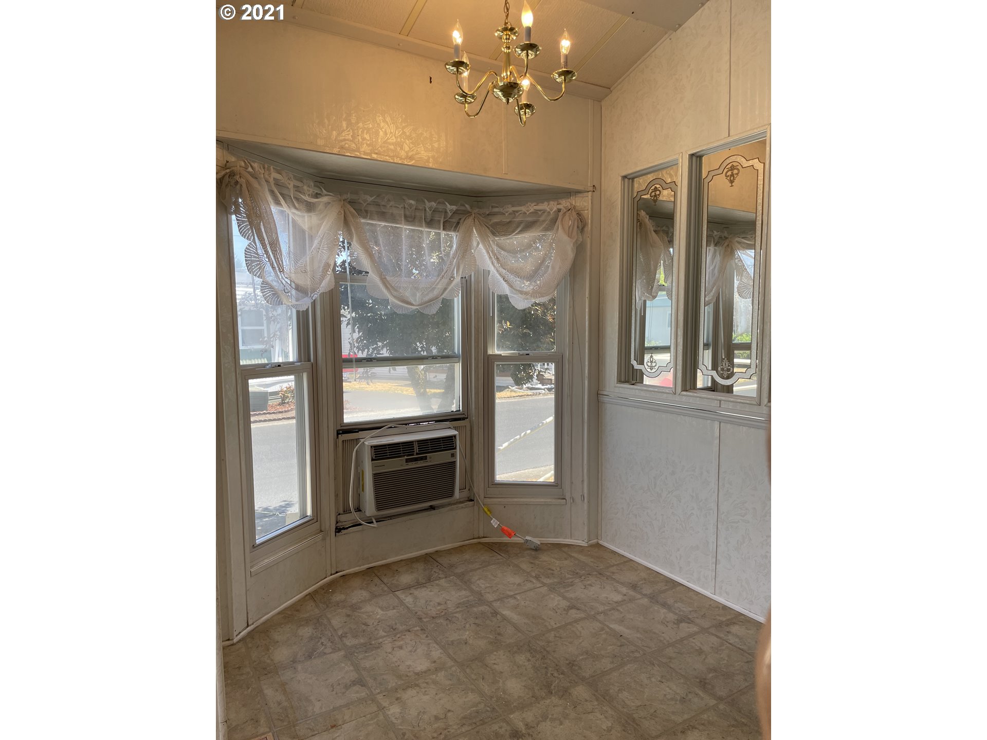 19776 Southeast Stark Street Portland, OR 97233 - Photo 6 of 18 a view of an empty room with a fireplace and a window