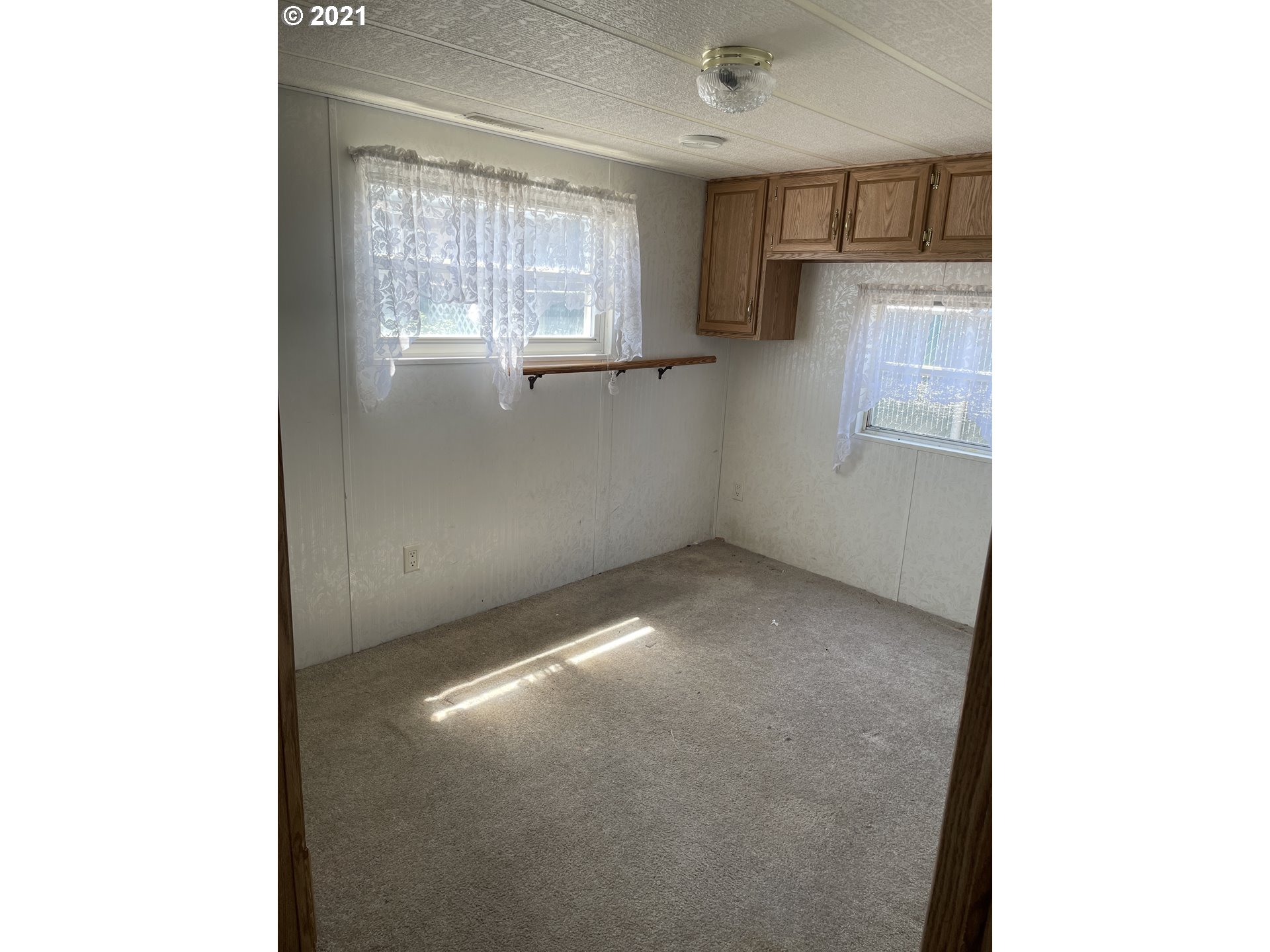 19776 Southeast Stark Street Portland, OR 97233 - Photo 7 of 18 a view of an empty room with a windows
