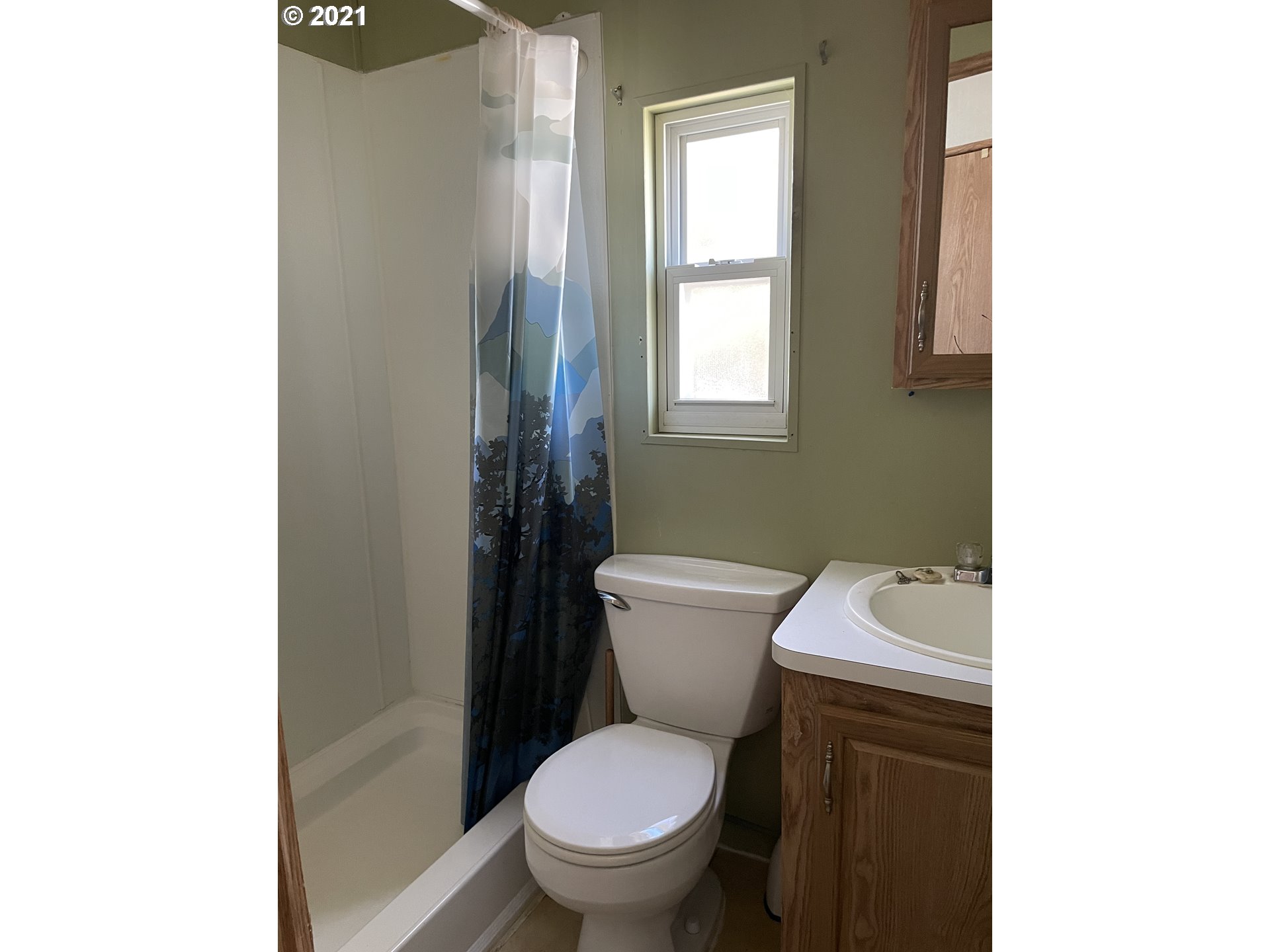 19776 Southeast Stark Street Portland, OR 97233 - Photo 9 of 18 a white toilet sitting next to a bathroom sink