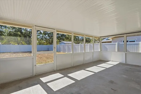 an aerial view of a swimming pool with outdoor seating