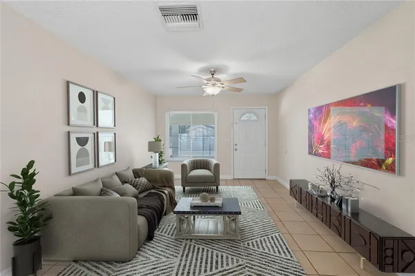 a living room with furniture and a chandelier