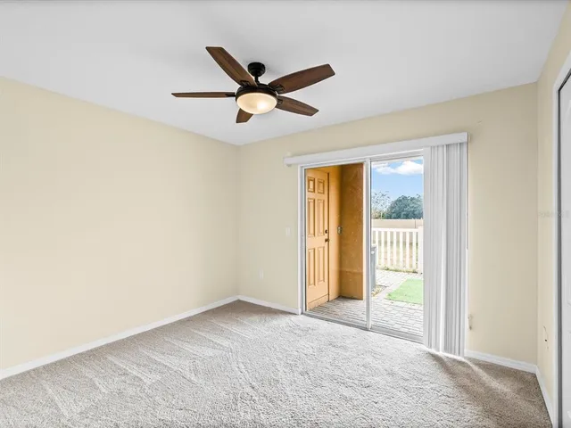 a view of a livingroom with a ceiling fan and window