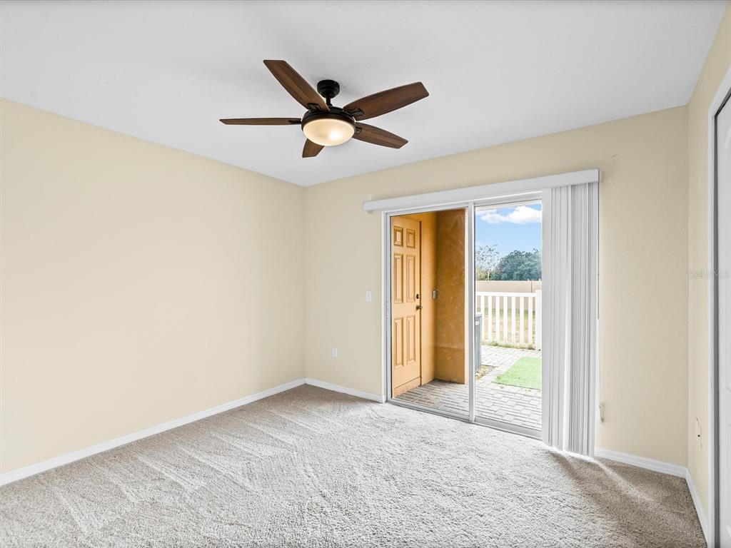 9779 Trumpet Vine Loop Trinity, FL 34655 - Photo 22 of 33 a view of a livingroom with a ceiling fan and window