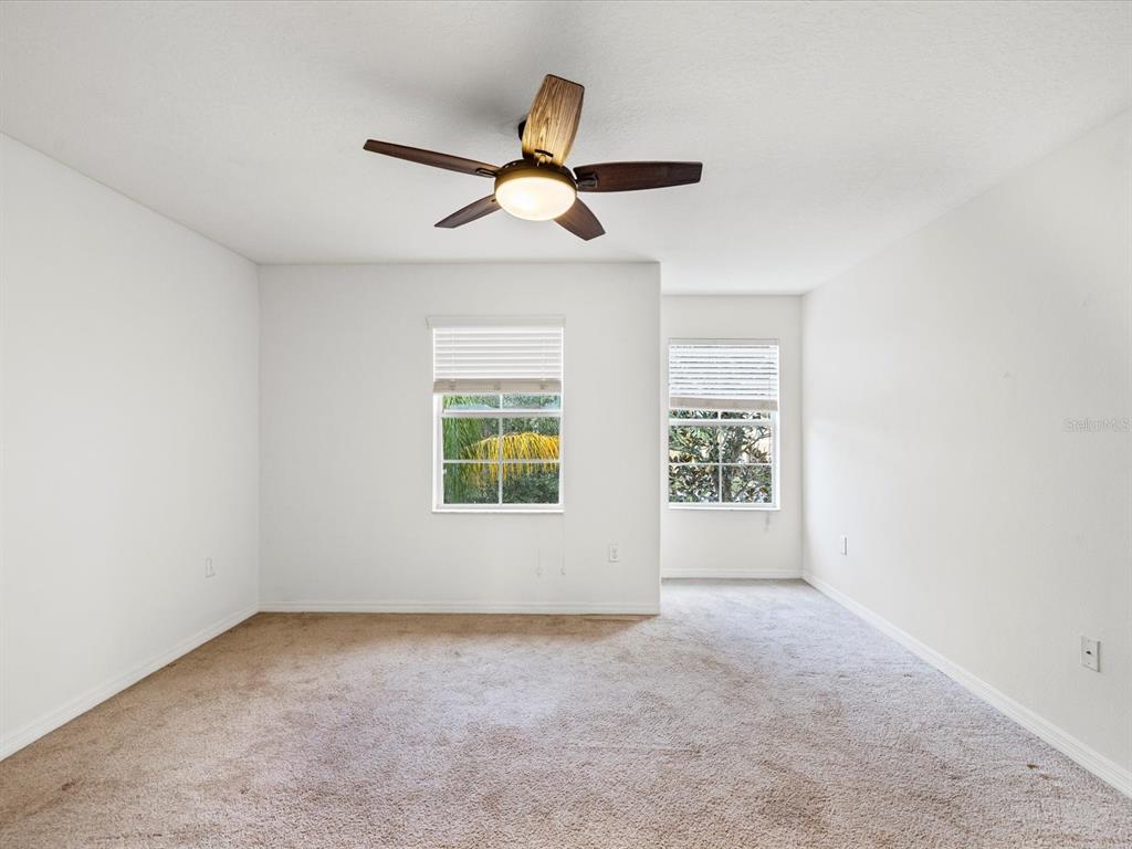 9779 Trumpet Vine Loop Trinity, FL 34655 - Photo 5 of 33 an empty room with windows and fan