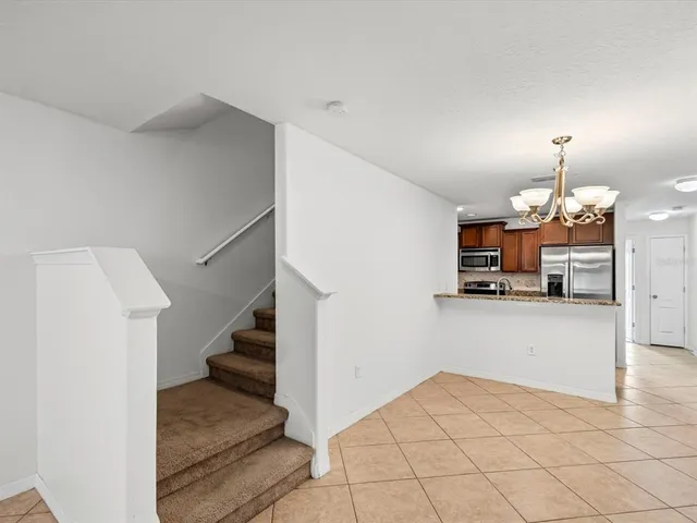 a view of a kitchen with furniture and a refrigerator