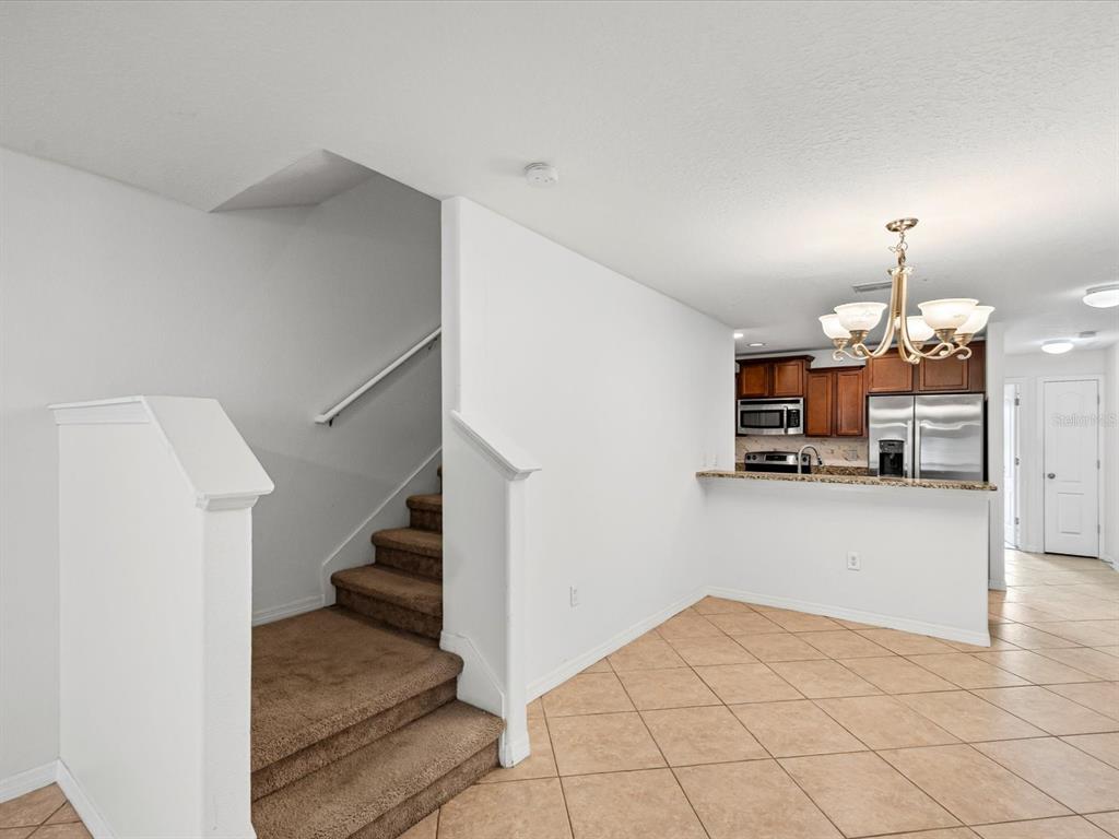 9779 Trumpet Vine Loop Trinity, FL 34655 - Photo 8 of 33 a view of a kitchen with furniture and a refrigerator