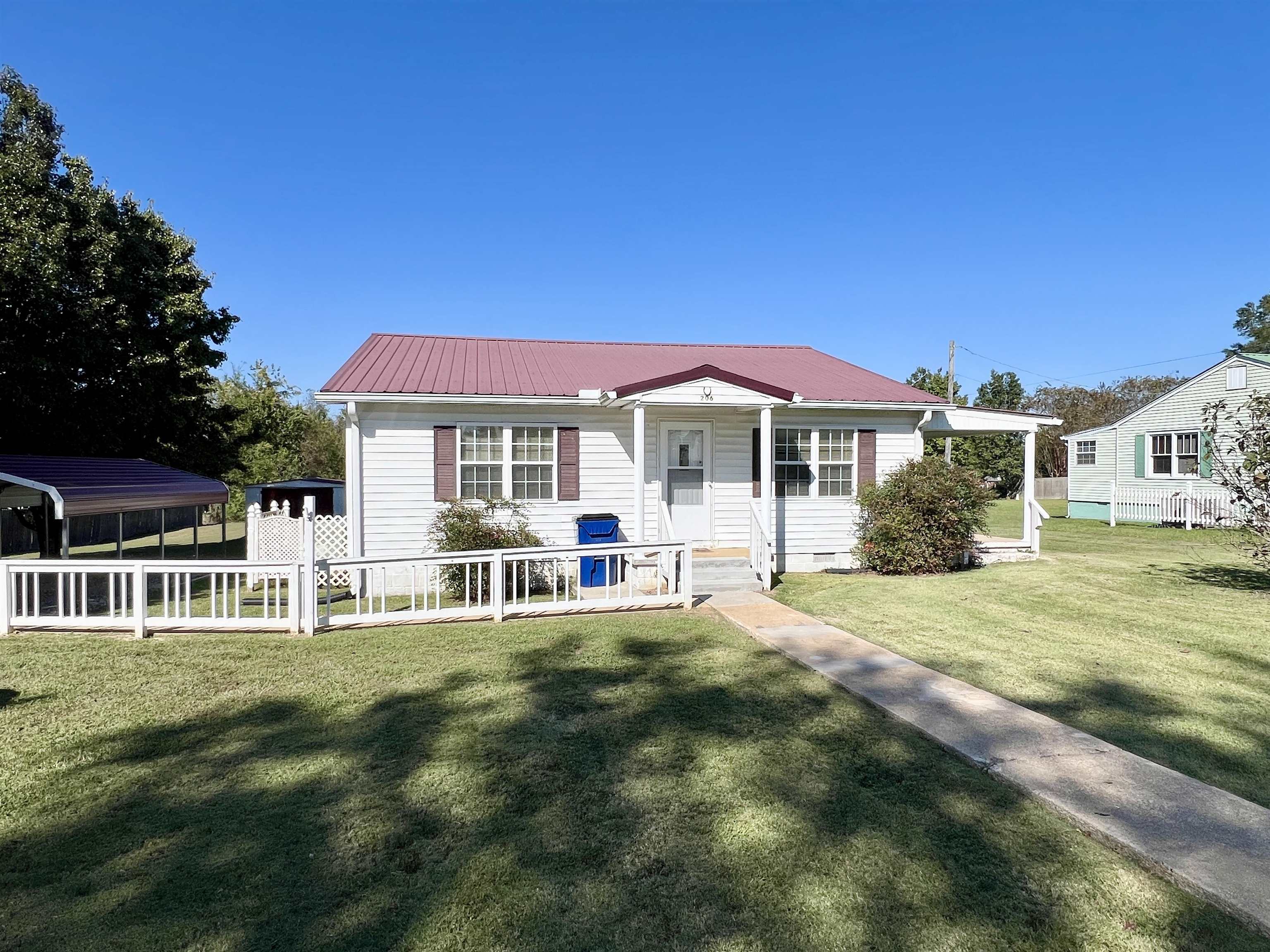 206 Willow Drive Adamsville, TN 38310 - Photo 16 of 21 a front view of a house with a garden