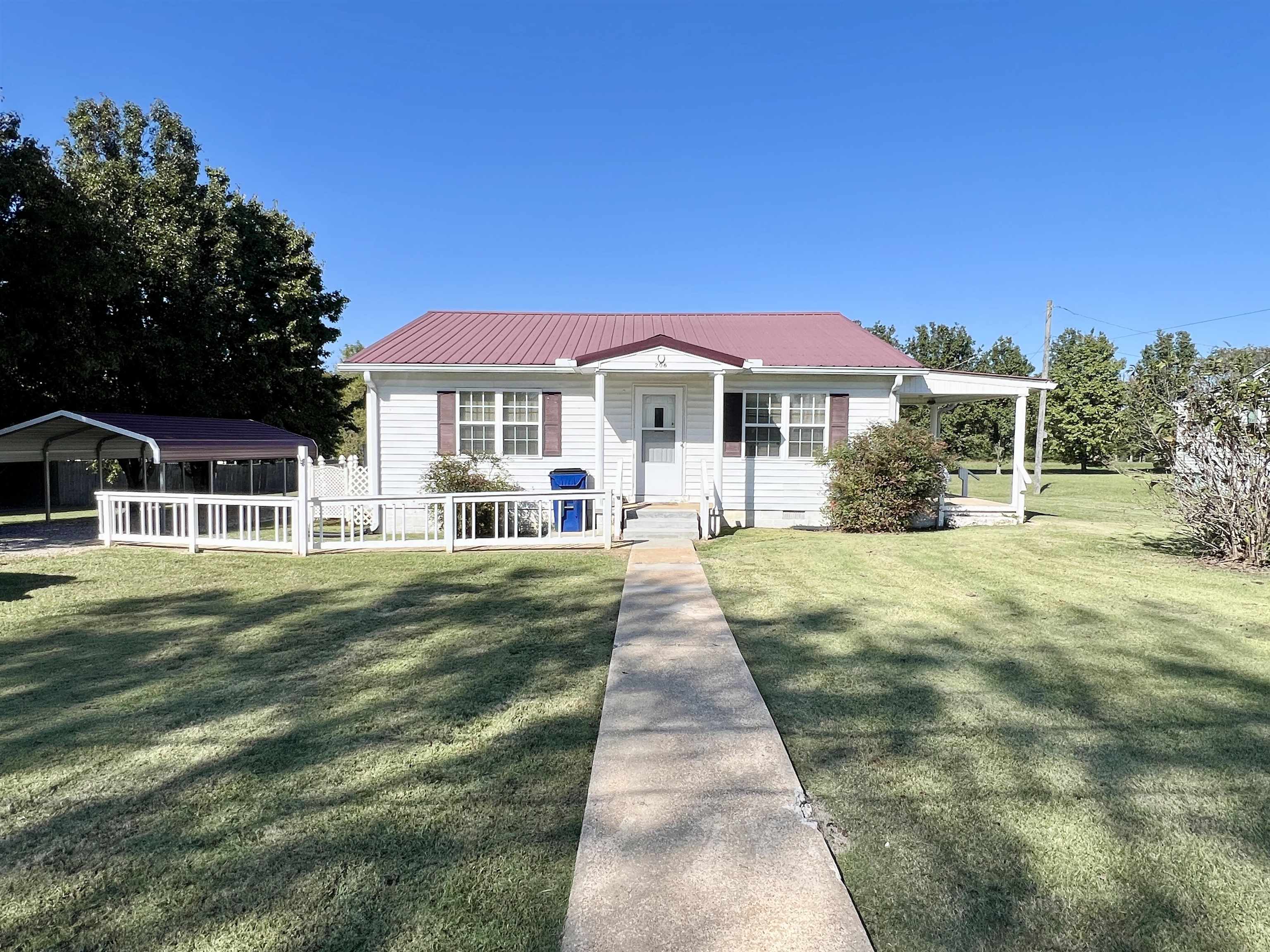206 Willow Drive Adamsville, TN 38310 - Photo 18 of 21 a front view of a house with a yard