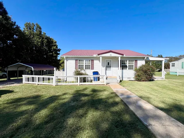 a front view of a house with a yard table and chairs