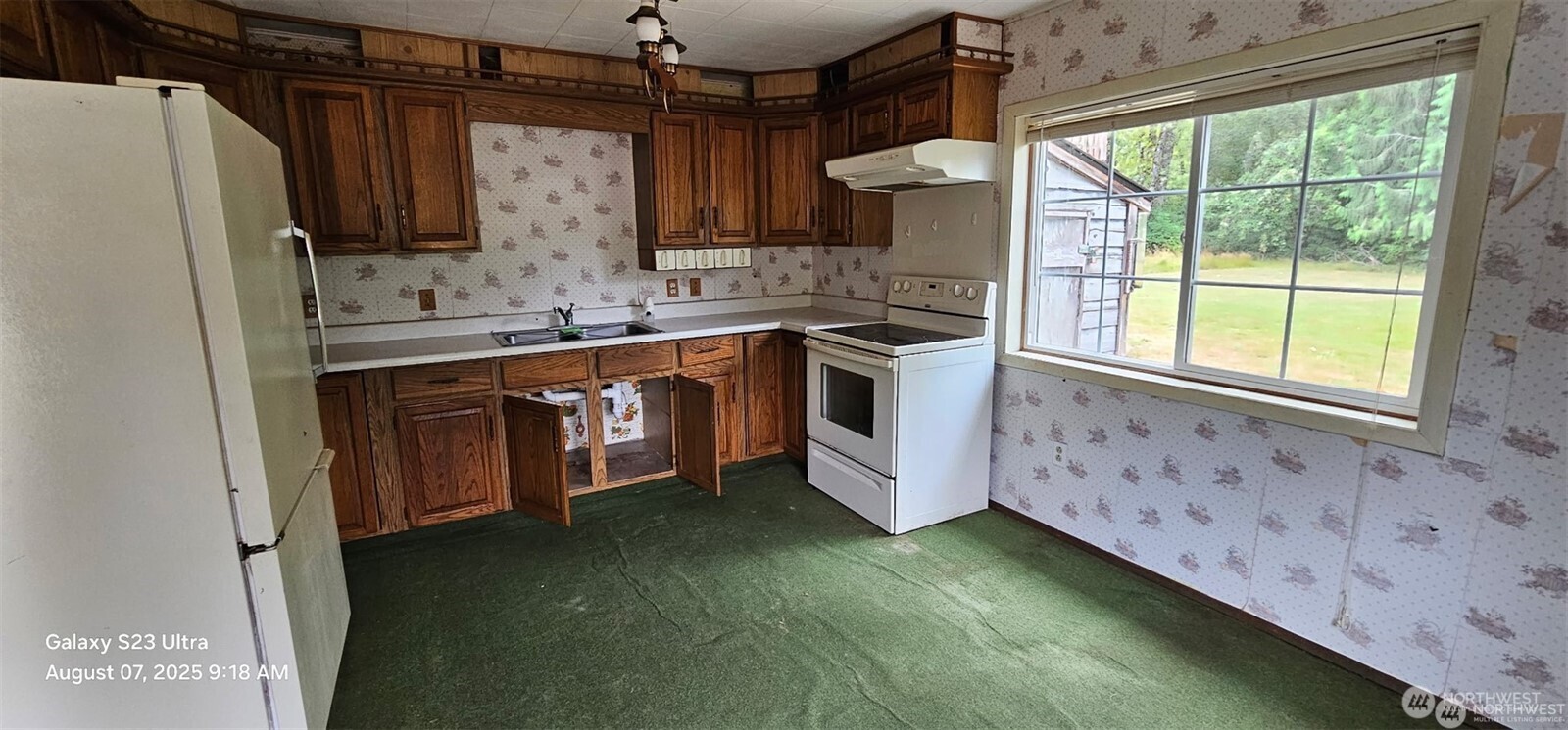 4086 Valley Highway Deming, WA 98244 - Photo 9 of 18 a kitchen with stainless steel appliances granite countertop a sink a stove and a refrigerator