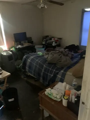 a bed sitting in a bedroom next to a window