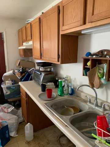 a kitchen with sink and cabinets