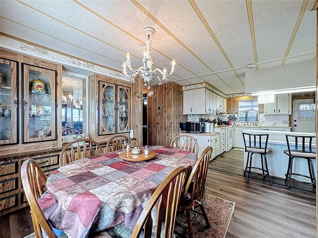 a living room with furniture a flat screen tv and a floor to ceiling window