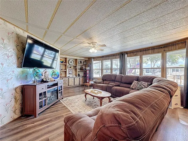 a bedroom with a large bed and a flat screen tv