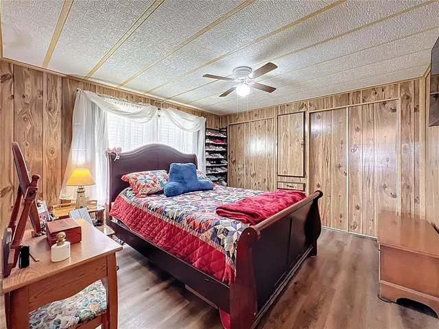 a bedroom with a bed a table and a large closet