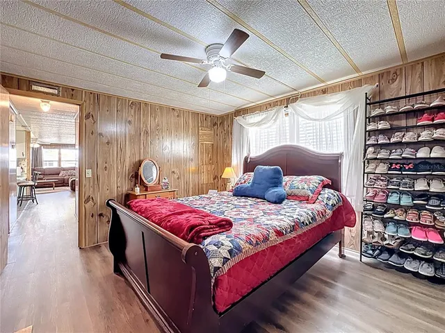 a bedroom with a large bed and a chandelier