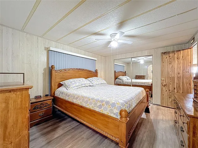 a bedroom with a bed and a mirror