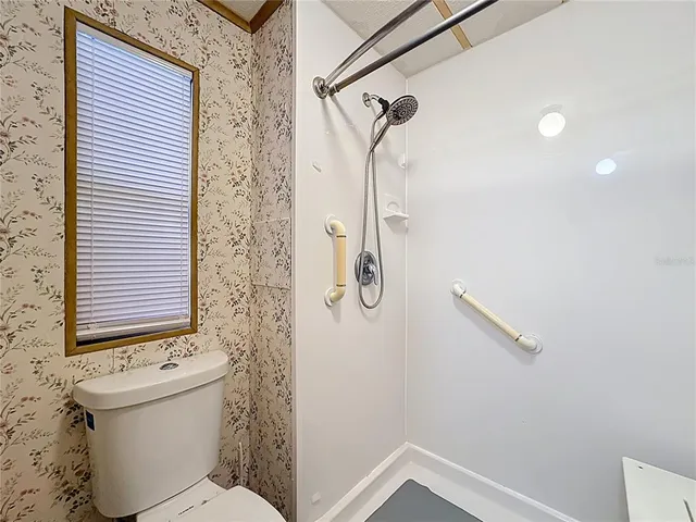 a view of a livingroom with wooden floor and white walls