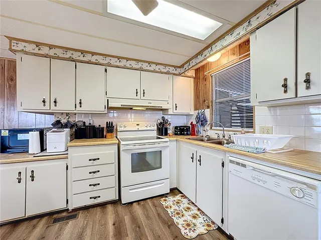 a kitchen with granite countertop a refrigerator and a stove