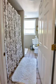 a bathroom with a toilet and a shower curtain
