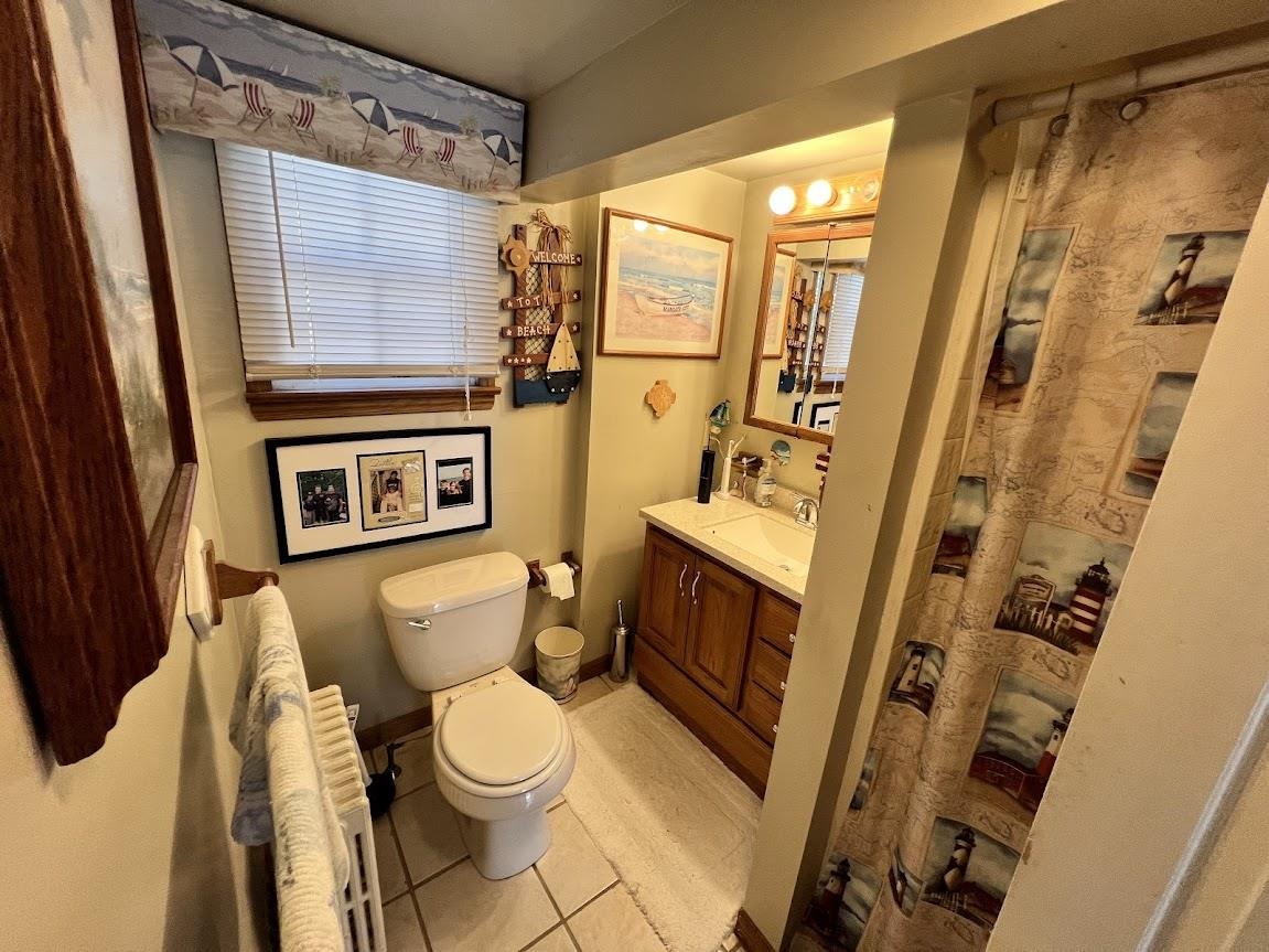 14 Lyndhurst Road Marmora, NJ 08223 - Photo 27 of 38 a white toilet sitting next to a bathroom sink and a shower