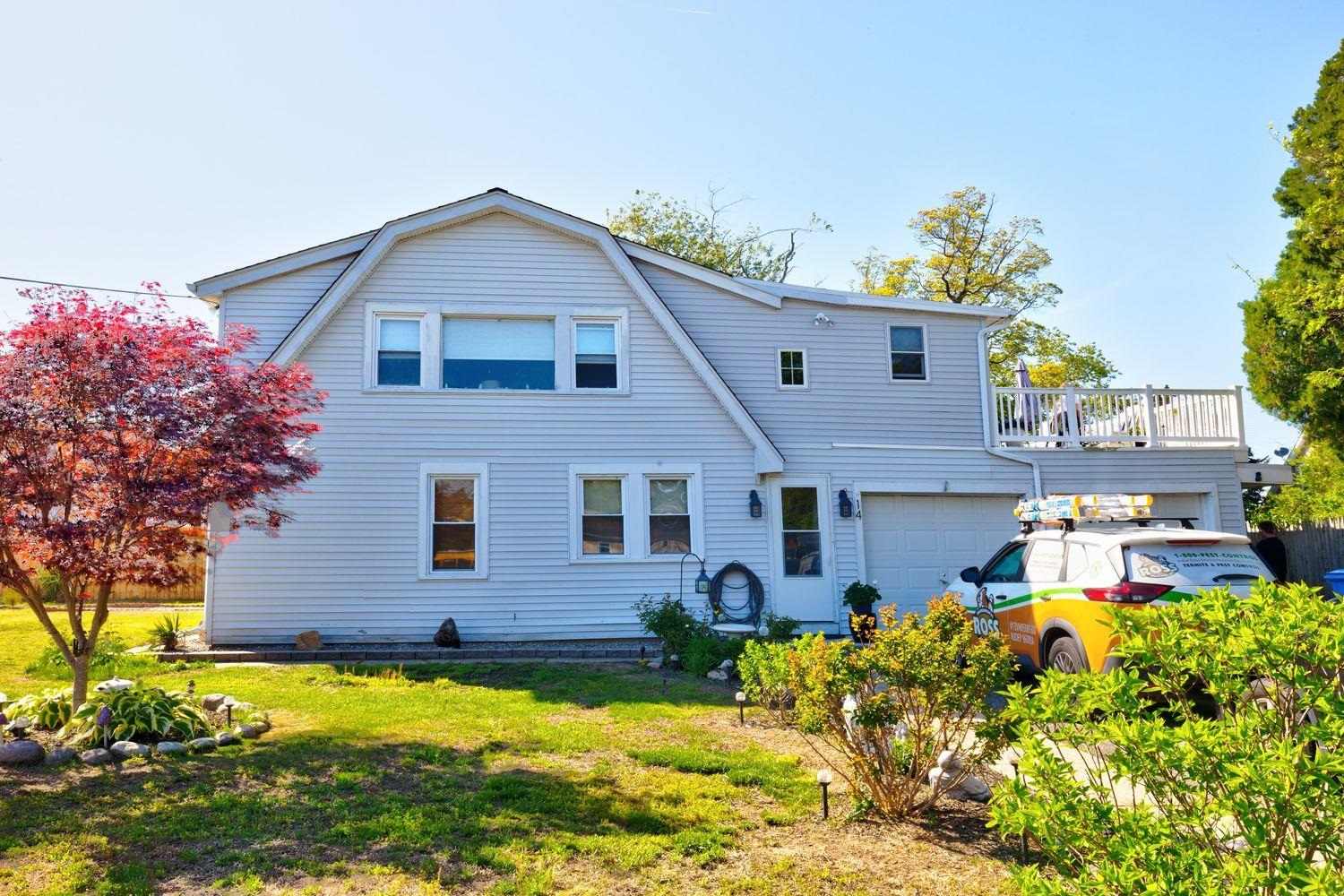 14 Lyndhurst Road Marmora, NJ 08223 - Photo 3 of 38 a front view of house with yard and trees in the background