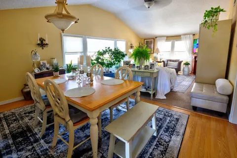 a view of a dining room with furniture and a chandelier