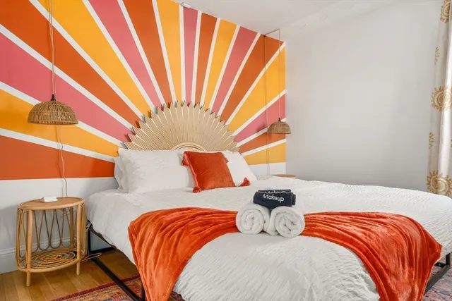 a bedroom with a bed and a window