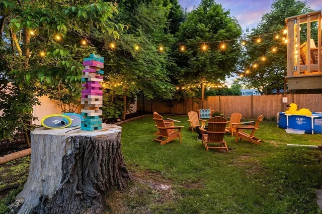 a view of a chairs and table in backyard of the house