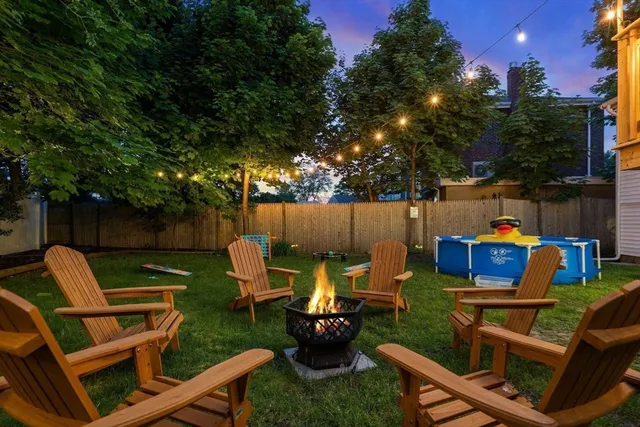 a view of a chairs and table in the back yard of the house