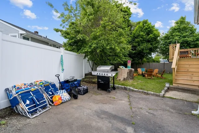 a view of a house with a yard and large tree