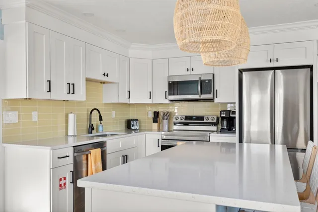 a kitchen with stainless steel appliances cabinets a sink and a counter space