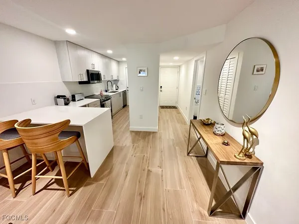 a view of a dining room with furniture and a mirror