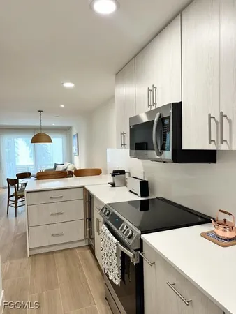 a kitchen with a sink cabinets and microwave