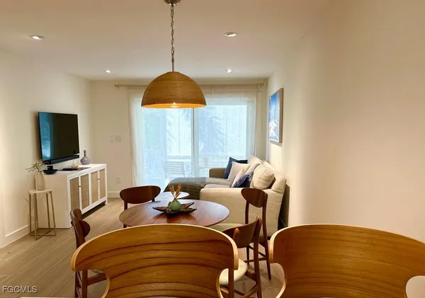a view of a livingroom with furniture and a flat screen tv