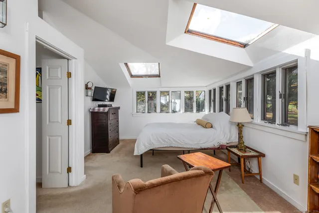 a bed room with furniture and a window