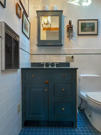 a bathroom with a sink a toilet and mirror