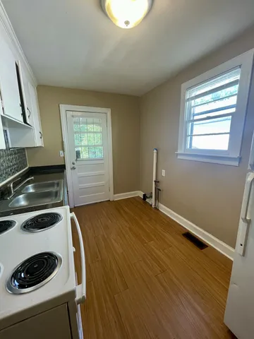 a kitchen with a sink and a stove top oven