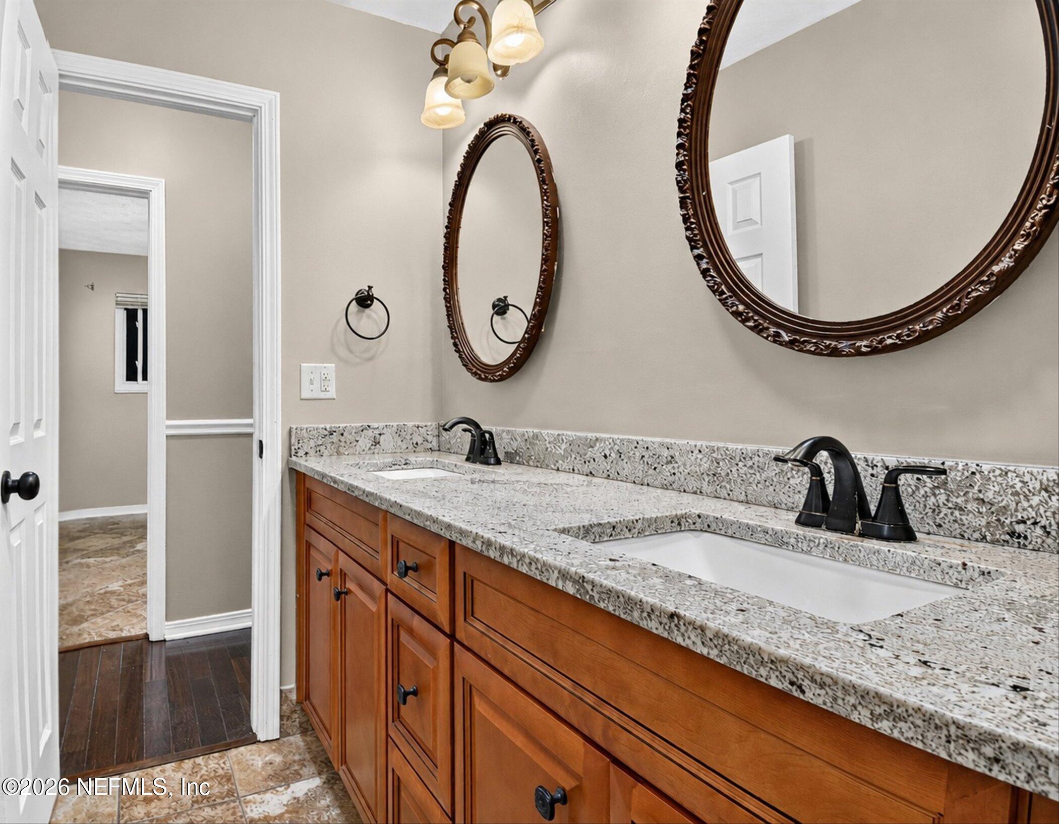 2705 Navajo Road Orange Park, FL 32073 - Photo 45 of 58 a bathroom with a granite countertop sink and a mirror