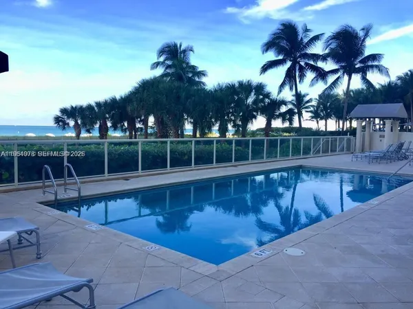 a view of swimming pool with outdoor seating and trees