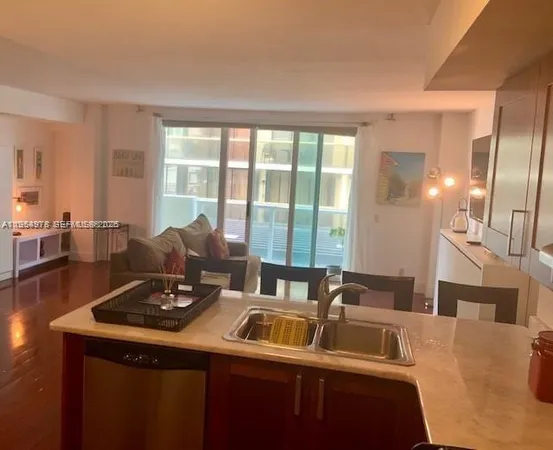 a view of a kitchen with a sink and large windows