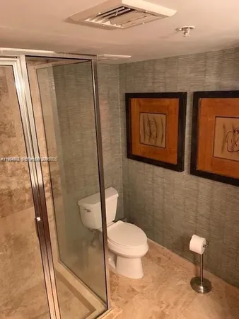 a bathroom with a toilet and a shower