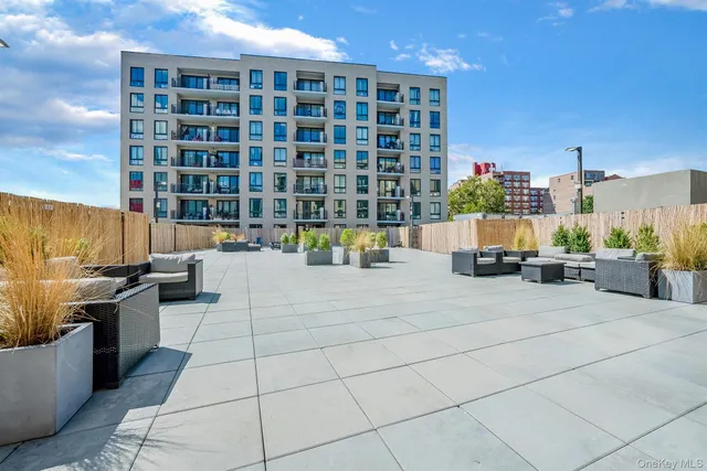 a view of roof with building and potted plants