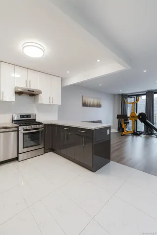 a living room with furniture gym equipment and a large window