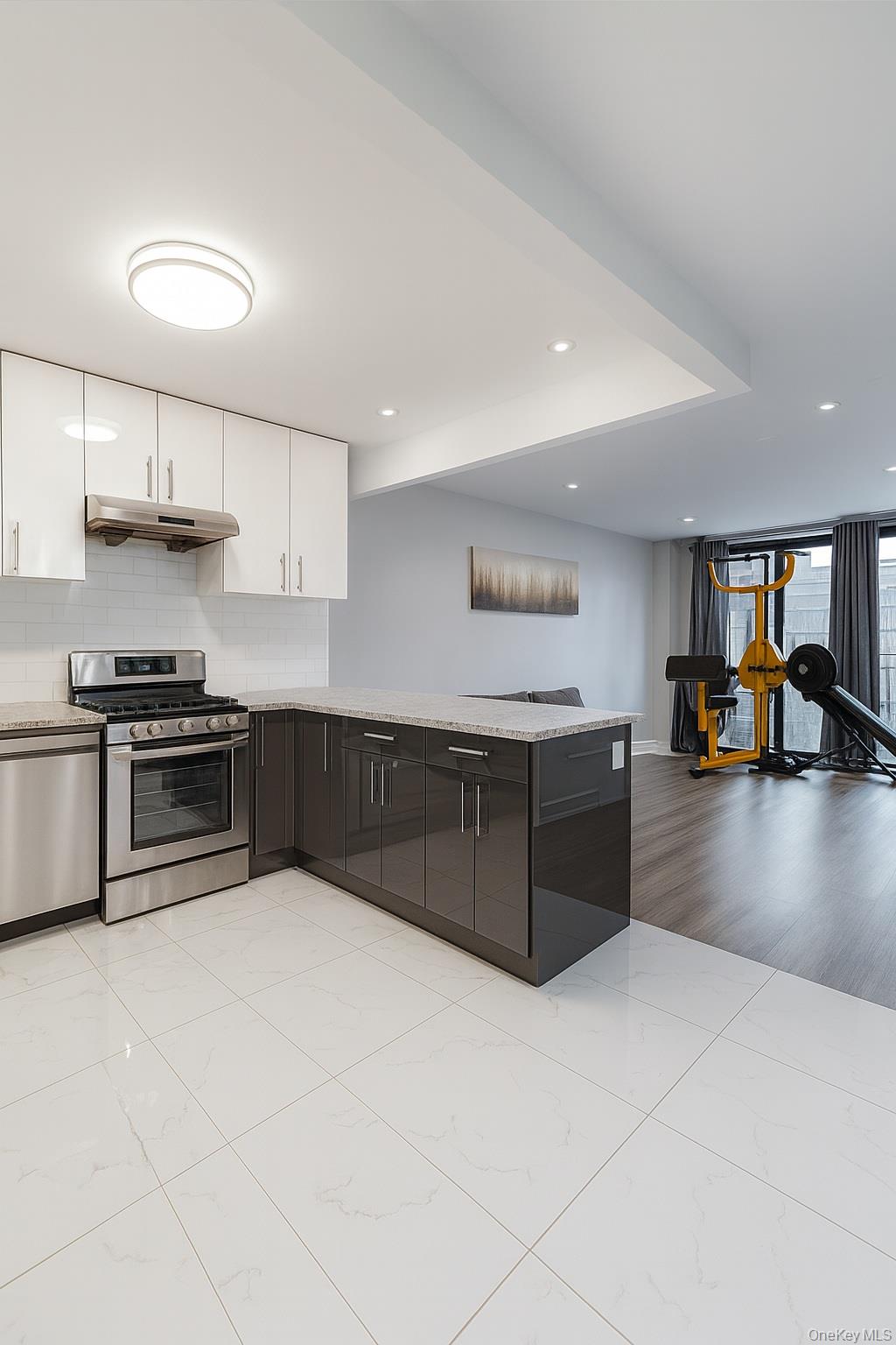 45-16 83rd Street, Unit E2D Queens, NY 11373 - Photo 5 of 11 a kitchen with stainless steel appliances a sink and a stove