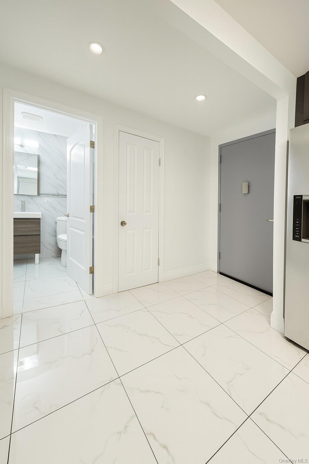 45-16 83rd Street, Unit E2D Queens, NY 11373 - Photo 8 of 11 a view of an empty room and a bathroom