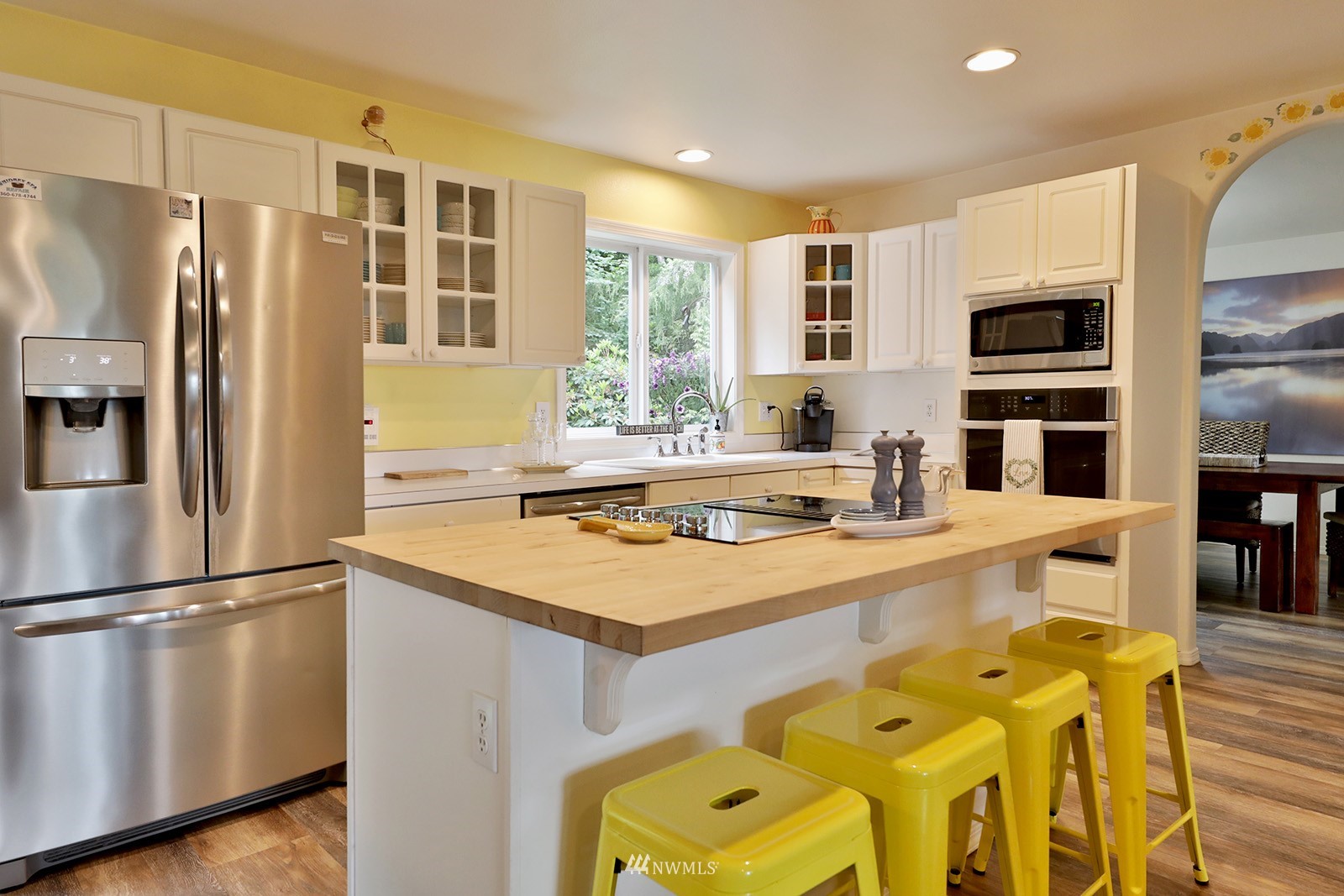 3277 East Harbor Road Langley, WA 98260 - Photo 19 of 40 a kitchen with stainless steel appliances granite countertop a sink a stove and a refrigerator